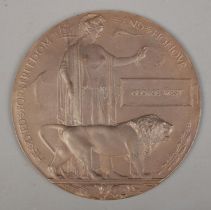 A World War One bronze memorial plaque/death penny awarded to George West.