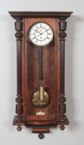 A 19th century German walnut Vienna single weight wall clock.