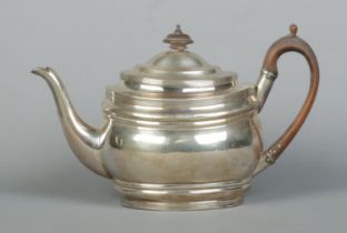 A George III silver teapot with wooden handle and turned finial. Assayed London 1804 by Samuel