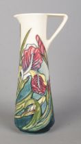 A Moorcroft pottery ewer decorated in the Iris design for the Moorcroft Collectors Club. Date cypher