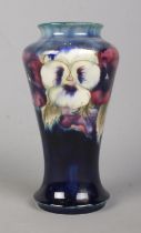 A Moorcroft pottery vase decorated in the Pansy design. Signed to base and impressed M72. Height