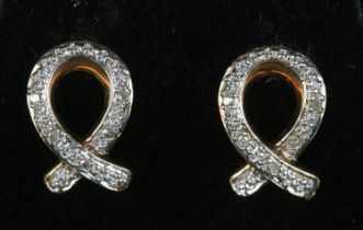 A pair of 9ct gold and diamond knot earrings. 1.8g.