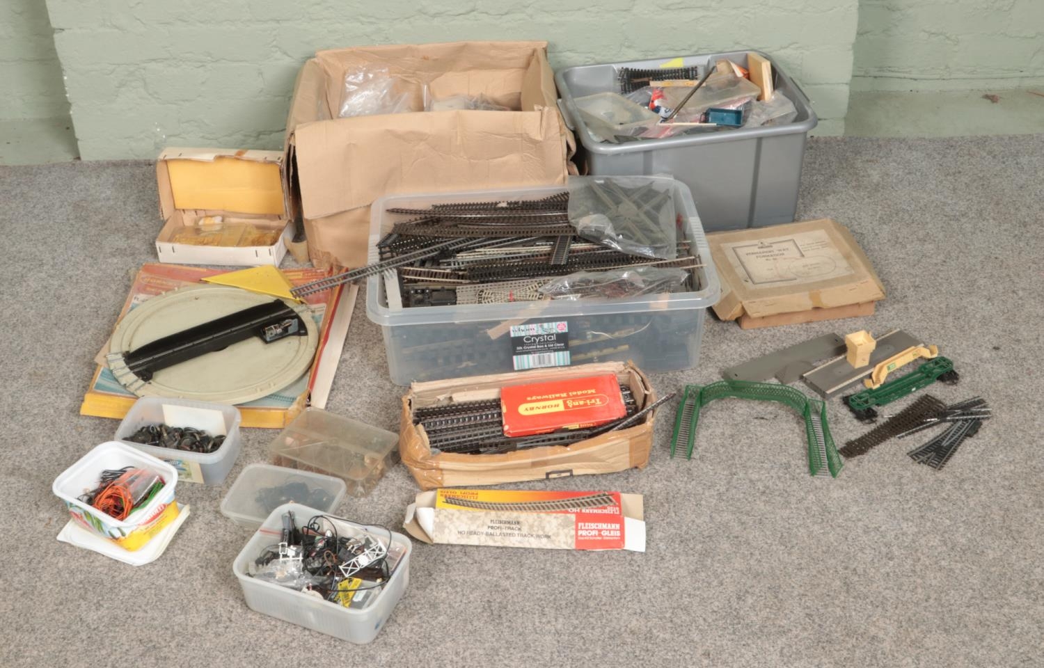 Three boxes of assorted model railway spares and repairs to include Hornby, Tri-Ang, Trix Twin