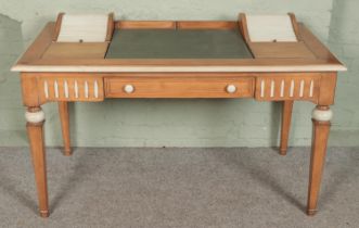 A vintage pine desk featuring painted highlights with leather inset top flanked by tambour