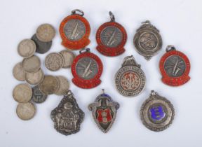 A good collection of silver fobs along with quantity of pre-1920 British silver three pence coins.