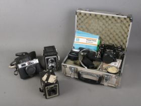 A collection of vintage cameras to include Rollop Enna, cased Praktica B200, Brownie Model C and