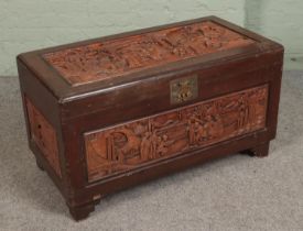 An oriental hardwood carved chest featuring camphorwood lining. Approx. dimensions 101cm x 53cm x