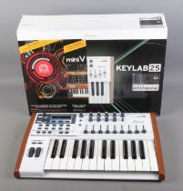 A boxed Arturia Keylab 25 Midi controller keyboard.