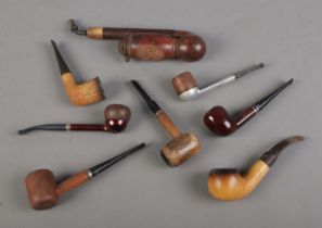 A collection of smoking pipes to include Jambo, Alco and Meerschaum examples.