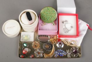 A collection of costume jewellery. Includes Mirage, Mizpah and other brooches, Radley watch, Guess