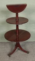 A three tier mahogany dumb waiter featuring drop leaf to each tier. Hx119cm Top section in need of