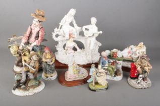 A collection of ceramic figures including Capodimonte and The Leonardo collection examples.