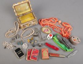 A box of collectables. Includes costume jewellery, silver ring, pen knives, cufflinks etc.