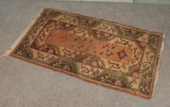 A wool rug with Aztec style pattern. 200x114cm