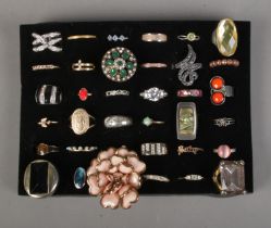 A collection of 36 costume jewellery dress rings to include floral, baby and bird examples.