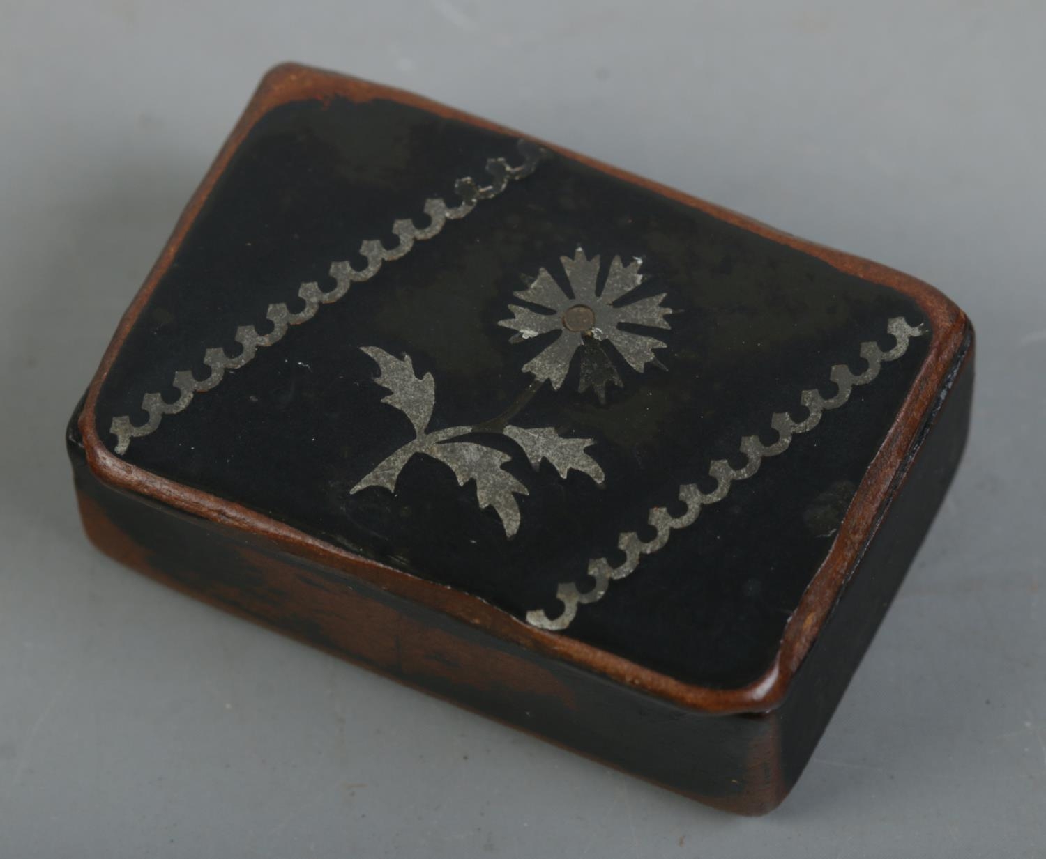 A Georgian papier mache snuff box with pewter inlay. Length 4.5cm