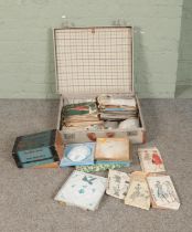 A suitcase with contents of vintage sewing patterns, Airlyne rugmaker, linens, etc.