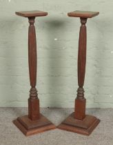 A pair of torchere/plant stands with reeded pedestal columns. Hx98cm