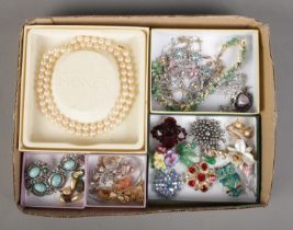 A tray of assorted costume jewellery to include boxed Monet pearl necklace, brooches, necklaces,