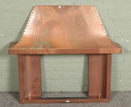 A vintage copper fire surround and canopy.