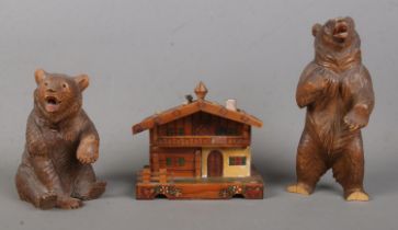 Two Black Forest style carved wooden bears together with a similar style music box, formed as a