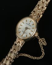 A 9ct gold ladies Sovereign wristwatch with decorative link strap and safety chain. Weight including
