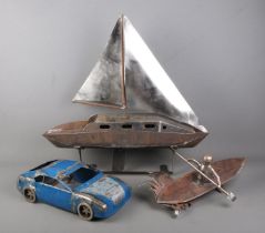 A collection of scratch built metal salvage models including sailing boat, speed boat and car.