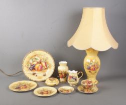 A collection of Aynsley Orchard Gold ceramics to include table lamp, milk jug, plates, small vase,