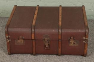 A vintage wooden bound steamer trunk.