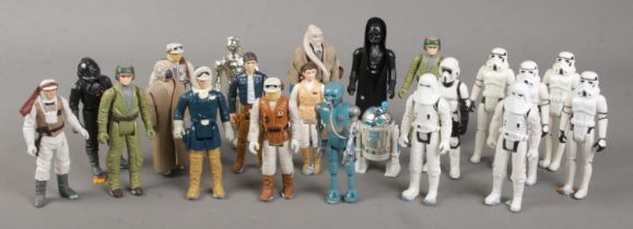 A collection of 1970s and 1980s Kenner Star Wars action figures. Includes 1977 Darth Vader, R2D2 and