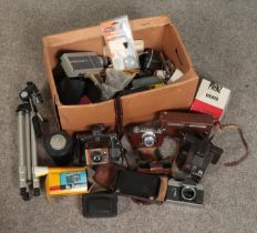 A box of photographic equipment. Includes Kodak, Polaroid, Coronet cameras, Pyramid tripod, Prinz