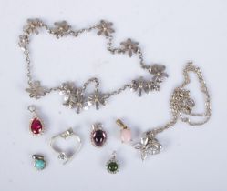 A collection of silver pendants and necklaces to include floral and heart examples. Approx. total