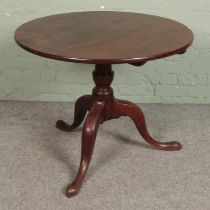 A tilt top table on three cabriole legs Diameter 90cm