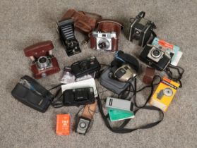 A box of photographic equipment. Includes Kodak, Canon, Coronet cameras etc.