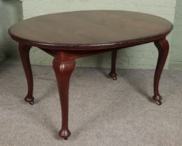 A mahogany extending dining table raised on castors. Hx75cm Wx106cm Dx137cm No additional leaf