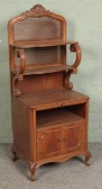 A French oak cabinet with bergere back and shelving over to cupboard doors. Hx134cm Wx54cm Dx41cm