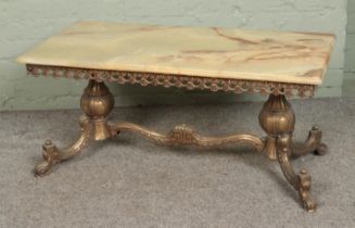 A brass and onyx coffee table. Approx. dimensions 50cm x 100cm.