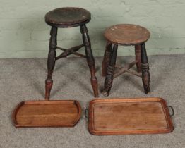 Two antique turned wooden stools including milking example along with two trays.