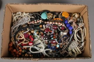 A large box of modern costume jewellery.