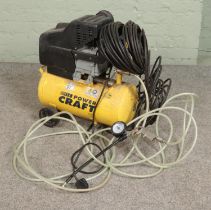 A Power Craft 24 litre air compressor.