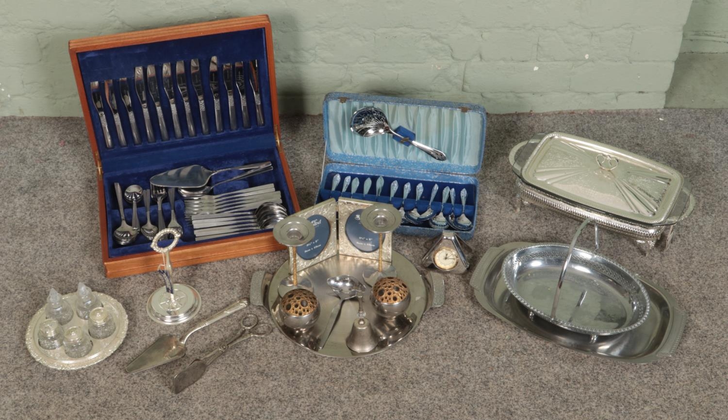 A large collection of metalwares, to include boxed sets of flatware, swing handled basket, serving