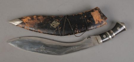 An Indian Kukri knife featuring lion head pommel with scabbard. CANNOT POST OVERSEAS