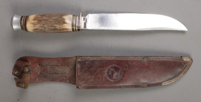 A Solingen Rostfrei hunting knife with antler horn handle and leather scabbard. CANNOT POST OVERSEAS