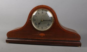An early 20th century inlaid mahogany dome top mantel clock. Chiming on a coiled gong. The