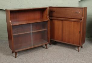 A pair of retro walnut side cabinets. One having glass sliding doors, the other with wooden