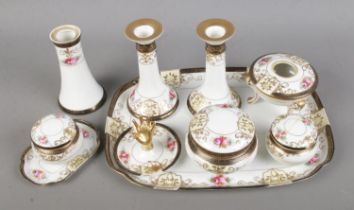 A Noritake dressing table set featuring pair of candlesticks, trinket boxes, tray, etc.