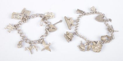 Two silver charm bracelets, with a collection of silver and white metal charms. Total, weight: 56.9.