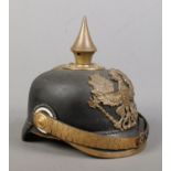 A World War One Imperial German officers pickelhaube bearing eagle badge with motto Mit Gott Fur