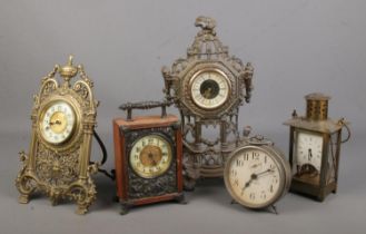 A collection of clocks including Veglia and German brass examples.