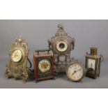 A collection of clocks including Veglia and German brass examples.